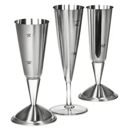 Cocktail shaker and martini glass, stainless steel shaker, three-piece design, V-shaped martini glass, olives on cocktail pick, clear liquid in glass in a sketch