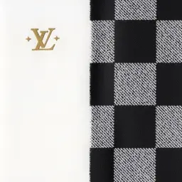 Louis Vuitton-Inspired Tactile Design Guide (1200 characters)

Logo: The interlocking "LV" monogram mimics two ribbons—one curved ("J"), one angular ("L")—meeting in symmetrical balance. Embossed or engraved, the letters feel crisp and unbroken, like polished metal or carved wood. Edges are smooth, solid, and elegantly precise.

Monogram Pattern: A grid of repeating shapes:

Quatrefoils: Four-petaled floral forms, rounded and slightly raised, like a clover pressed into wax.

Diamonds: Sharp-cornered shapes nestled between flowers, their pointed edges contrasting the soft petals.

Hidden "JL": Miniature logos tucked into negative spaces, detectable as subtle ridges.
Texture: Uniform rhythm, like tiles underfoot; durable, finely woven fabric with a subtle grain.

Damier Checkerboard: Chessboard-like squares alternating textures:

Smooth: Cool, polished leather (glossy finish).

Textured: Matte canvas (pebbled feel).
Edges are razor-sharp, creating stability through repetition.

Colors (Textural Analogies):

Gold: Cool, metallic smoothness (like a coin’s surface), radiating warmth.

Rich Browns: Earthy, aged leather—dry, powdery, timeless.

Contrasts: Light/dark interplay evokes rhythmic balance (alternating piano keys).

Essence: Precision, heritage, and tactile harmony—luxury felt through symmetry, contrast, and hidden details.

Do this for the initials J L instead of L and V